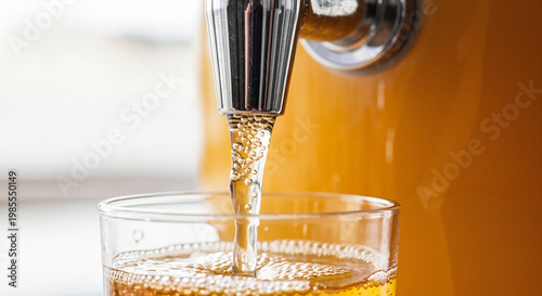 Refreshing beverage being poured into a glass from a dispenser  