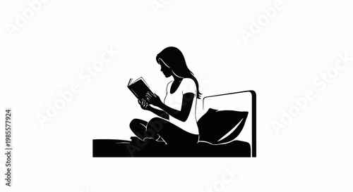 Woman sitting cross-legged on a bed reading a book
