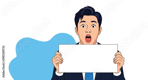 Surprised young man in a dark business suit holds up a blank white board against a simple blue and white background.