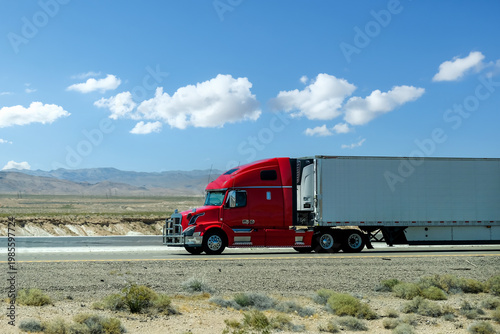 semi truck driving on highway through green nature and mountains. Commercial vehicle transport for logistics and freight shipping.