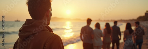 Group of friends walking along beach at sunset with cheerful atmosphere and warm tones. Friends enjoy sunset by shoreline with ocean waves and golden light. Concept beach gathering during sunset.