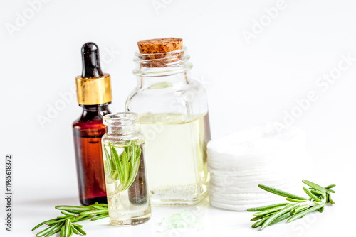 organic cosmetics with extracts of herbs rosemary on white background