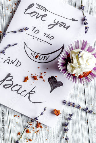 concept of Valentine's Day cupcakes wooden background top view