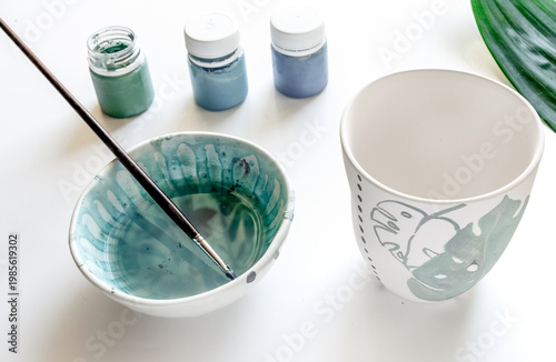 painted ceramic cup on white background