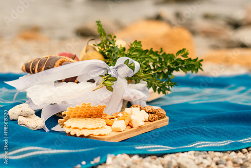 spring picnic breakfast scene with sweet snacks on sea rocky beach outdoors