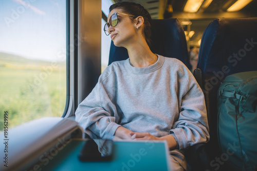 Female passenger relaxing during peaceful train journey