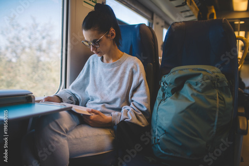 Female passenger reading during journey