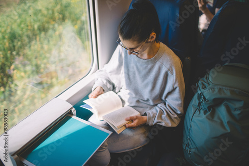 Female passenger reading during journey