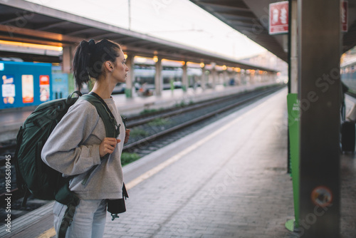 Solo traveler with backpack at railway station