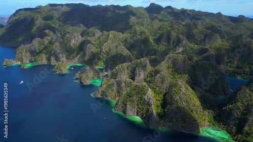 Coron Lagoon with limestone karsts turquoise waters. Smooth aerial view drone