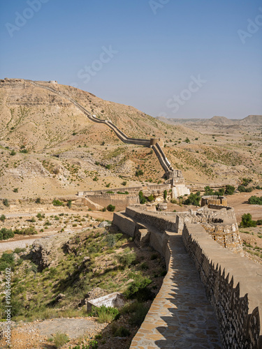 Vertical desert landscape view of stone ramparts and Sann gate at ancient Ranikot fort aka Great Wall of Sindh, Jamshoro, Sindh, Pakistan