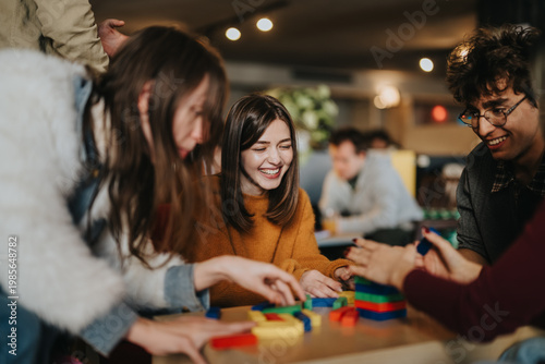 Fotografía A group of students and friends play with colorful wooden blocks and smile together