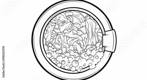 Close up of laundry inside a washing machine drum with suds