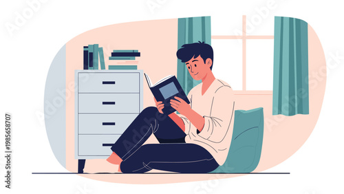 Young man sitting comfortably on the floor of his bedroom reading an interesting book in a relaxing atmosphere at home.