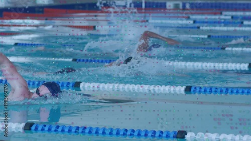 Vertical video: Center swimmer breathing and causing splashes as lanes holding steady swimming pace
