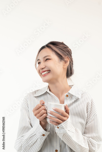 Happy young asian woman holding a cup coffee isolated on white background.