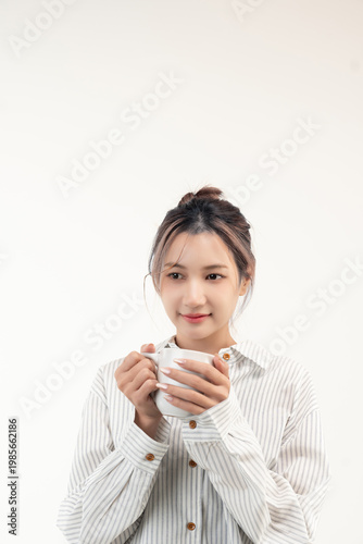 Happy young asian woman holding a cup coffee isolated on white background.