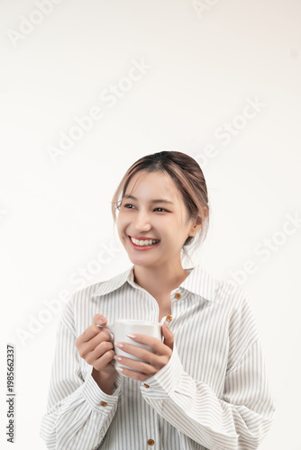 Happy young asian woman holding a cup coffee isolated on white background.