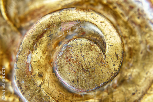 Close View of a Golden Spiral Decoration Showing Signs of Age and Wear in a Detailed Pattern
