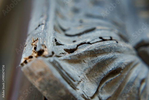 Wood Damage on a Carved Frame Shows Signs of Wear and Age in a Domestic Setting