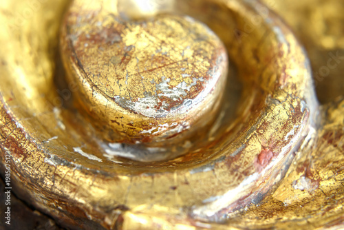 Close up View of a Golden Sculpture Showing Details of Texture and Color in a Museum Gallery Setting