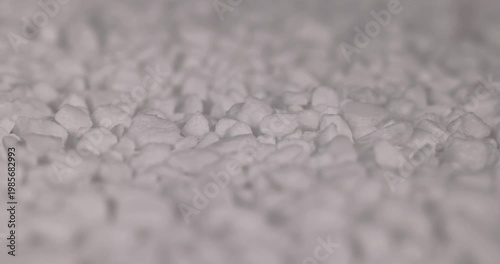 white coarse solid salt that is used in dishwashers to improve and soften water, white coarse crystals of special salt for dishwashers for good and long-lasting dishwasher operation
