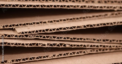 Corrugated cardboard is stacked in rows, multi-layered corrugated cardboard with porous edges and a fleecy surface under soft light with an authentic look and high detail of packaging.