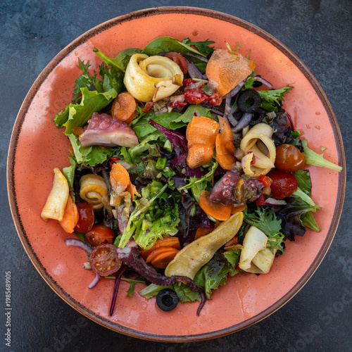Seafood salad with octopus, squid and fresh vegetables