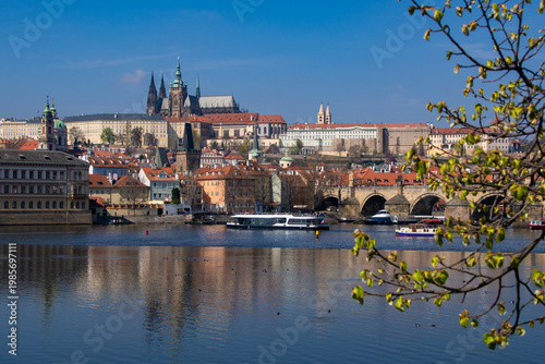 Prague Castle, Charles Bridge and boats on Vltava River in Prague, Czech Republic