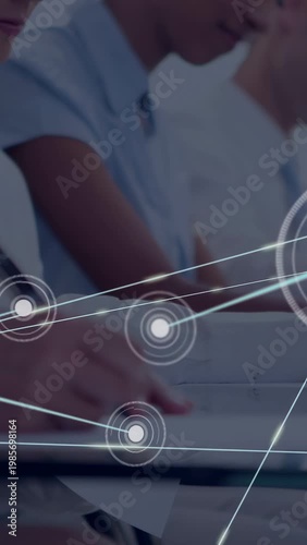 Vertical video: Hand writing in class, node appearing and expanding network over hand for training