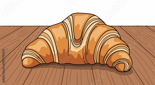 A golden-brown croissant rests on a wooden surface