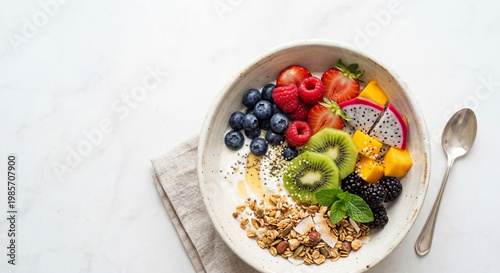 Colorful healthy breakfast bowl with fresh fruits granola and yogurt top view