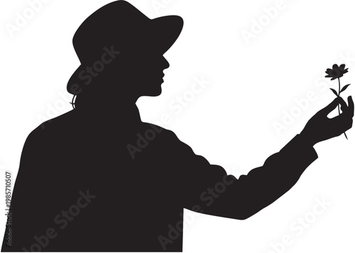 Close Up Silhouette Profile of a Person Wearing a Stylish Hat Gently Holding a Single Delicate Flower Representing Nature and Romantic Appreciation
