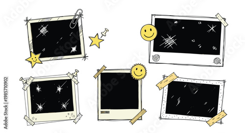 Collection of blank instant photo frames decorated with tape stars paper clips and smiley faces for a creative scrapbook look.