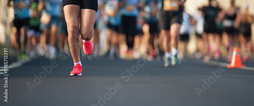 Marathon running race, people feet on city road, runners run urban marathon in the the city