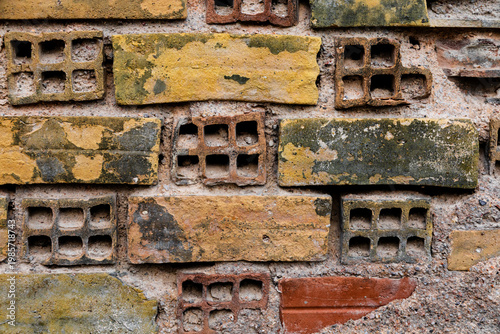 Background. Close-up. A section of an old wall made of assorted colored bricks