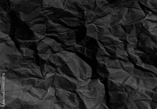 Black crumpled paper sheet texture background