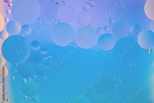Abstract macro-texture featuring translucent bubbles of various sizes, a soft light blue background, smooth color transitions, a top-down view, copy space included, banner format.