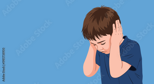 Sad young boy closing his ears with both hands to avoid loud noise or overwhelming sounds while looking down with a frown.