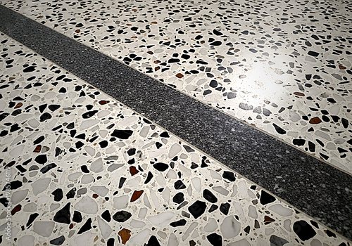 A black line on a white and black speckled surface