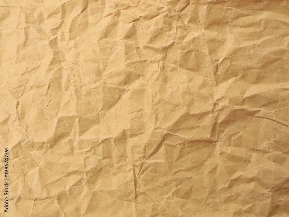 Obraz premium Crumpled brown kraft paper texture background. Perfect for vintage backgrounds, organic packaging concepts, or rustic design elements