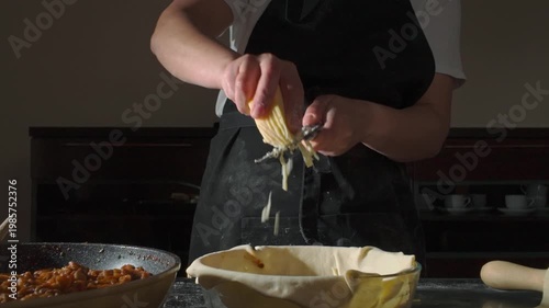 Slow Motion Close-Up of Hands Grating Fresh Cheese into a Bowl for Cooking