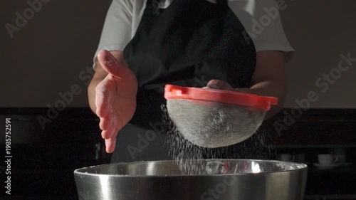 Chef Sieving White Flour into a Bowl in Slow Motion for Baking Preparation