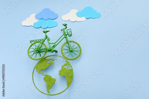 World bicycle day. Green bicycle riding a clean energy path on planet earth