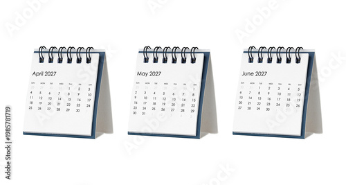 Close up of three spiral desk calendars for the first quarter of 2027. April, May, and June pages displayed for Q2 scheduling, financial goals, and winter season planning. Isolated white background.