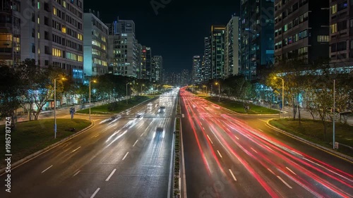Long Exposure City Street at Night with Car Light Trails and Modern Skyscrapers