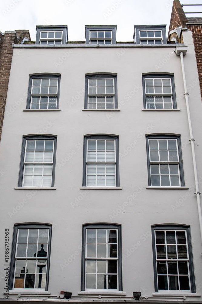 Fototapeta premium British Residential Building Facade With Symmetrical Windows in Classic Style