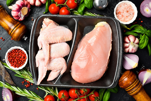 Fresh meat. Set of raw chicken meat. Meat on a plastic black container from the market. Close-up.