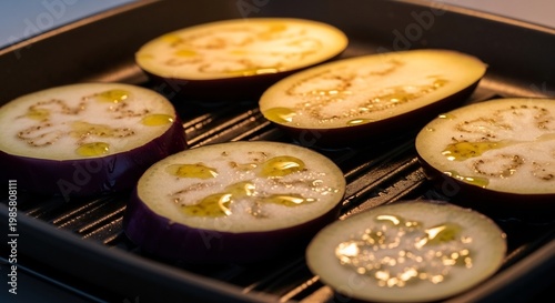 Sliced Eggplant Grilling with Olive Oil in a Pan.