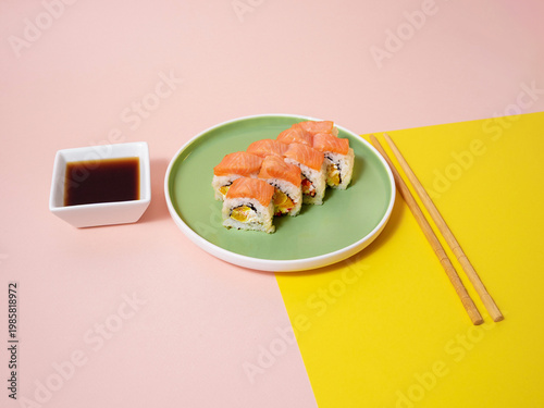 Artistic presentation of salmon sushi on pastel background